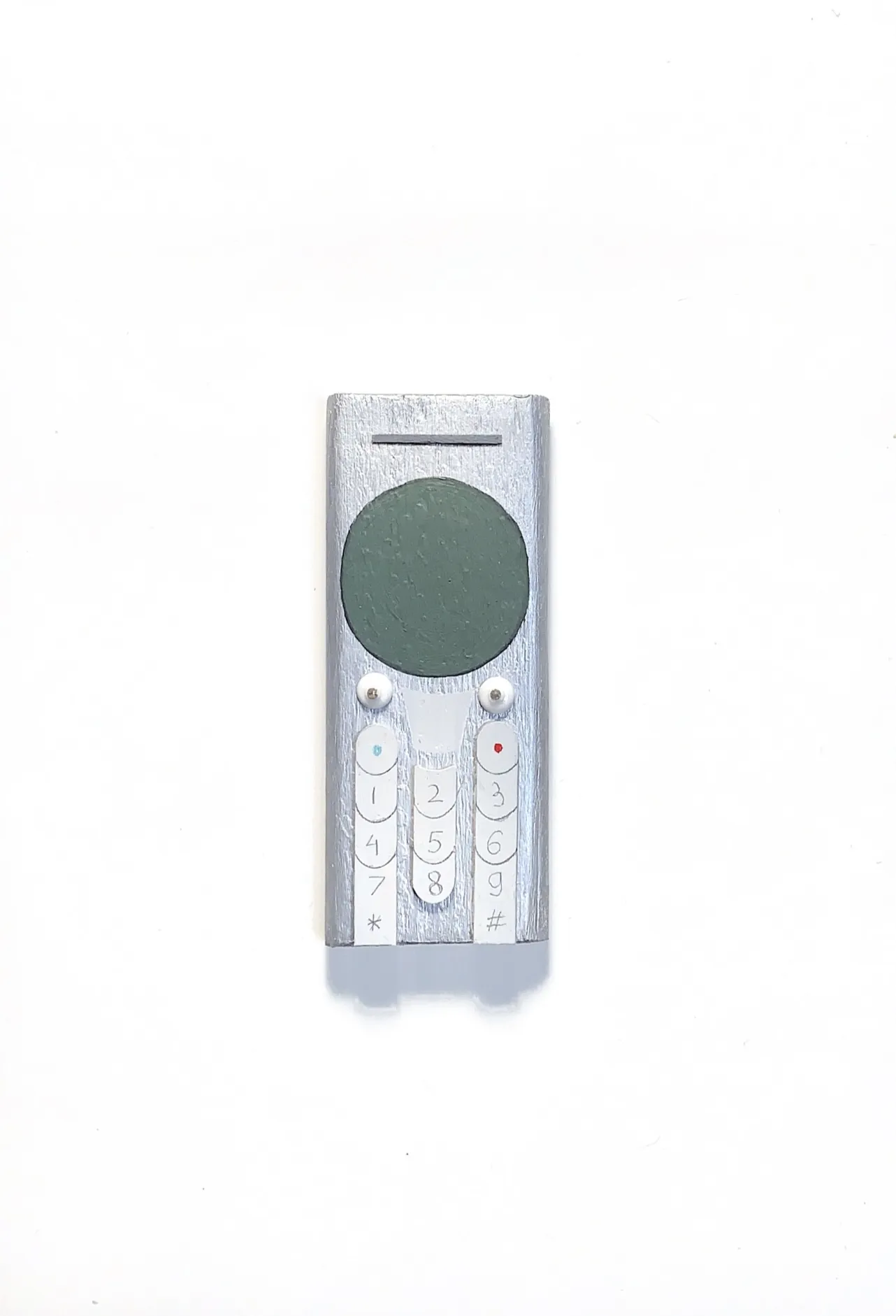 Image of Phones by Adriana Shportan, size: The average size of one phone 10 cm × 5 cm × 1.5 cm, made of wooden blocks, acrylic paint, and found/recycled materials;, Installation medium, from London, part of the “When It Is Our Turn to Be Adults” series Photo 6 of 17.